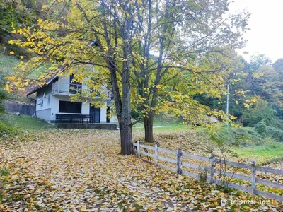a house on a hill with a fence and a tree at Villa Mostanica, Kozarska Dubica