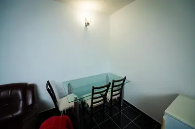 a room with two chairs and a table with a light on the wall at Villa Mostanica, Kozarska Dubica