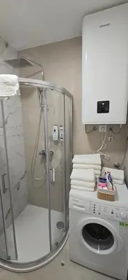 a washing machine and a shower in a bathroom at Apartment Lazarus with garage Banja Luka in Banja Luka