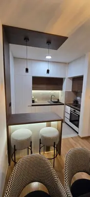 a kitchen with a table and chairs and a counter at Apartment Lazarus with garage Banja Luka in Banja Luka