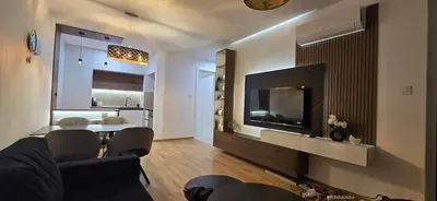 a living room with a couch and a tv and a table at Apartment Lazarus with garage Banja Luka in Banja Luka