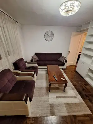 a living room with two couches and a coffee table at Nova varos apartman in Banja Luka
