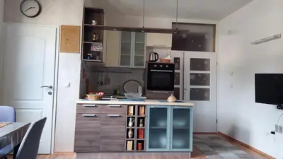 a kitchen with a blue island in the middle at Apartman Vlašićki san in Vlasic