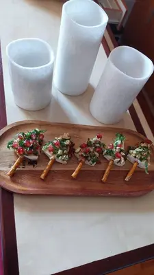 a wooden plate topped with food on top of chopsticks at Apartman Vlašićki san in Vlasic