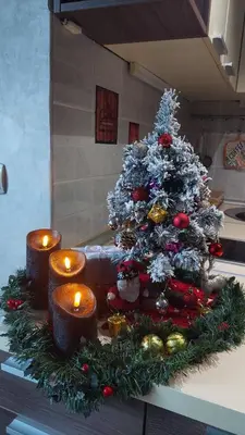 a christmas tree on a kitchen counter with candles at Apartman Vlašićki san in Vlasic