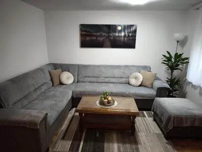 a living room with a couch and a coffee table at Malta in Livno