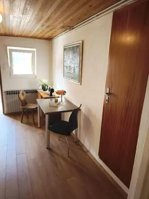 a dining room with a table and a door at Malta in Livno
