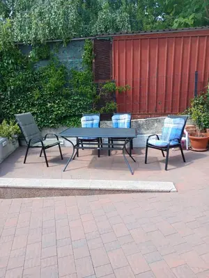 a picnic table and two chairs on a patio at Malta in Livno