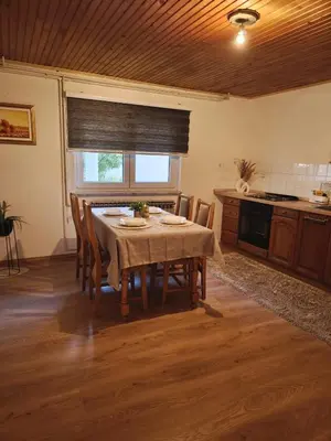 a dining room with a table and chairs in a kitchen at Malta in Livno