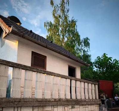 a house with a fence in front of it at Malta in Livno