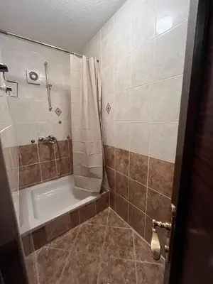 a bathroom with a shower and a tub and a sink at StayBihac in Bihać