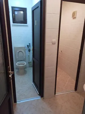 a bathroom with a toilet and a glass door at StayBihac in Bihać