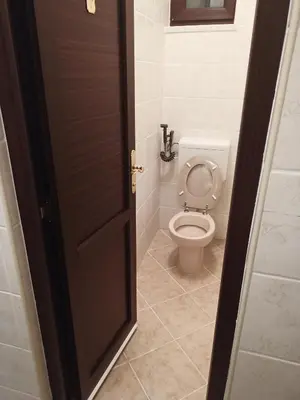 a door open to a bathroom with a toilet at StayBihac in Bihać