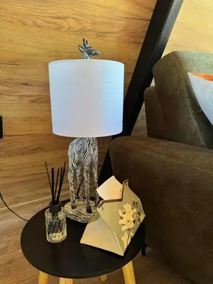a lamp on a table next to a couch at Villa Natura in Bosanska Gradiška