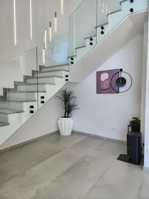 a staircase in a house with a potted plant at La Villa Luxury Home Bihac in Bihać