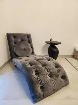 a brown leather chair in a room with a table at La Villa Luxury Home Bihac in Bihać