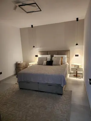 a bedroom with a large bed and a rug at La Villa Luxury Home Bihac in Bihać