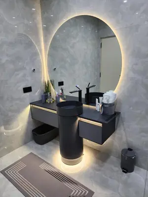 a bathroom with a black toilet and a sink at La Villa Luxury Home Bihac in Bihać