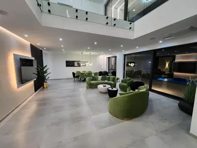 a living room with green couches and chairs at La Villa Luxury Home Bihac in Bihać