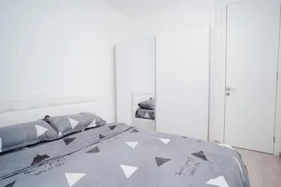 a bedroom with a bed with a gray comforter at Dolce notte in Železnička Stanica Incel