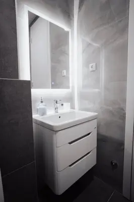 a white bathroom with a sink and a mirror at Dolce notte in Železnička Stanica Incel