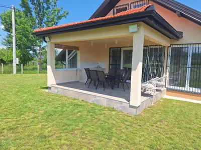 a patio with chairs and tables on a house at Holiday home Biskupici in Visoko