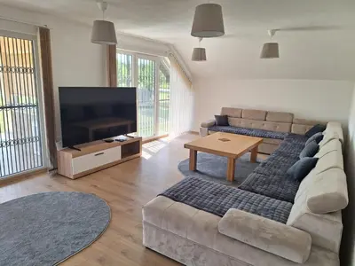 a living room with a couch and a flat screen tv at Holiday home Biskupici in Visoko