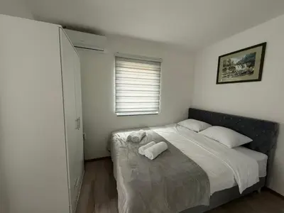 a bedroom with a bed with two towels on it at Apartmani Vanilla in Zavidovići