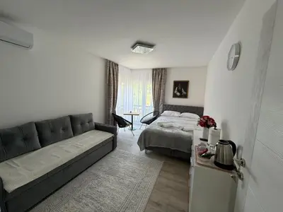 a living room with a couch and a bed at Apartmani Vanilla in Zavidovići