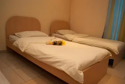 two beds with a stuffed animal on top of them at Hostel Fortuna in Banja Luka