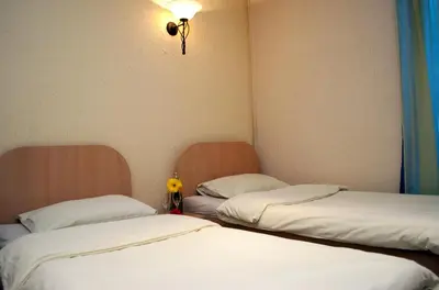 two beds sitting next to each other in a room at Hostel Fortuna in Banja Luka