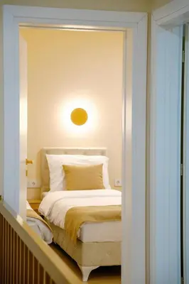 a bedroom with a white bed with a light above it at LUXIA PRIVATE ESTATE Sauna & Outdoor lounge with Fireplace in Bihać