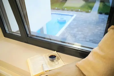 a window with a book and a glass of wine at LUXIA PRIVATE ESTATE Sauna & Outdoor lounge with Fireplace in Bihać
