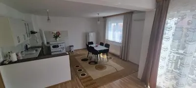a kitchen with a table and chairs in a room at Apartman Ivan in Tomislavgrad