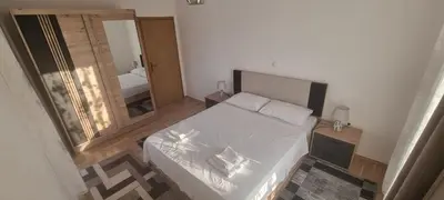 a small bedroom with a bed and a mirror at Apartman Ivan in Tomislavgrad