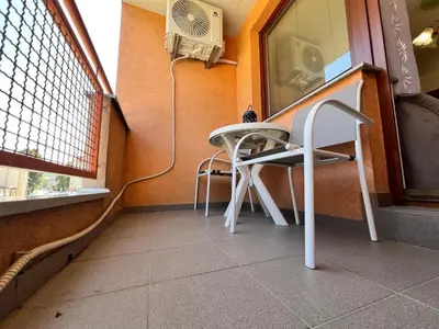 a small table and a chair in a room at GRADINA - Stan na dan in Doboj