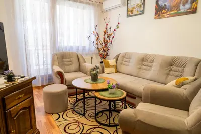 a living room with a couch and a table at GRADINA - Stan na dan in Doboj