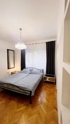 a bedroom with a bed and a chandelier at Banja Luka Apartment Brigita in Banja Luka