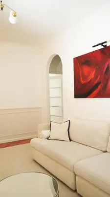 a living room with a white couch and a red painting at Banja Luka Apartment Brigita in Banja Luka