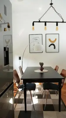 a dining room with a black table and chairs at Banja Luka Apartment Brigita in Banja Luka