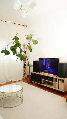 a living room with a tv and a table at Banja Luka Apartment Brigita in Banja Luka