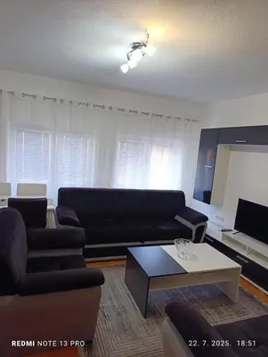 a living room with a couch and a coffee table at Apartman Omar in Bihać