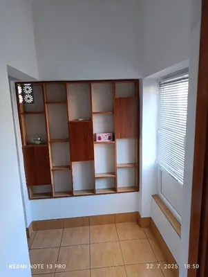 a room with shelves and a window at Apartman Omar in Bihać