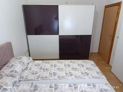 a bed in a room with a large television at Apartman Omar in Bihać
