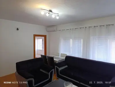 a living room with two chairs and a couch at Apartman Omar in Bihać