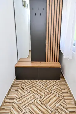 a wooden bench sitting on top of a tiled floor at Apartman Nina in Jajce