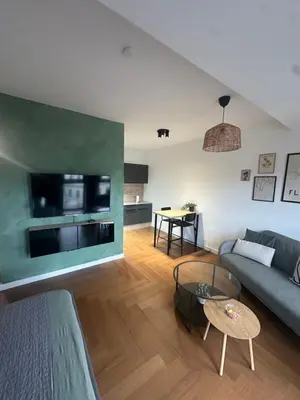 a living room with a couch and a table at Zs Apartment in Tuzla