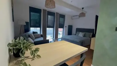 a living room with a table and a couch at Zs Apartment in Tuzla