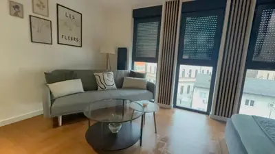 a living room with a couch and a glass table at Zs Apartment in Tuzla
