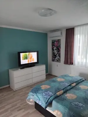 a bedroom with a bed and a flat screen tv at Apartman Breskvica in Bihać